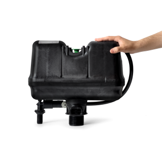 Flushmate pressure-assist vessel on a white background with hand resting on top of the vessel.