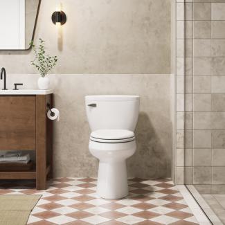 Interior of a home restroom in neutral tones showing a toilet and sink.